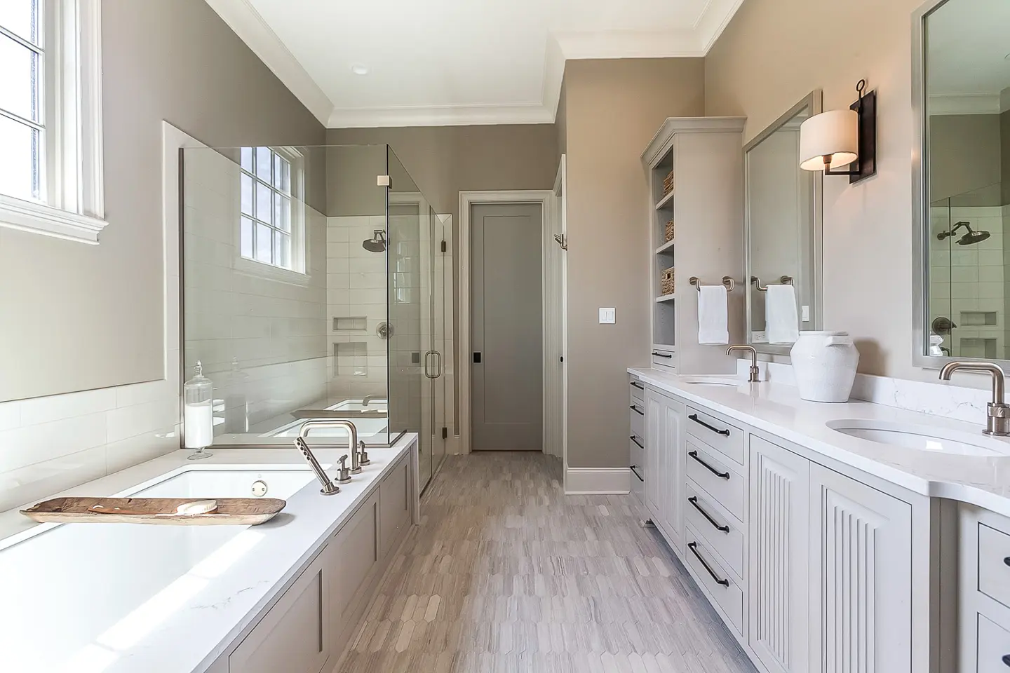 A bright, modern bathroom with a bathtub and double sinks.